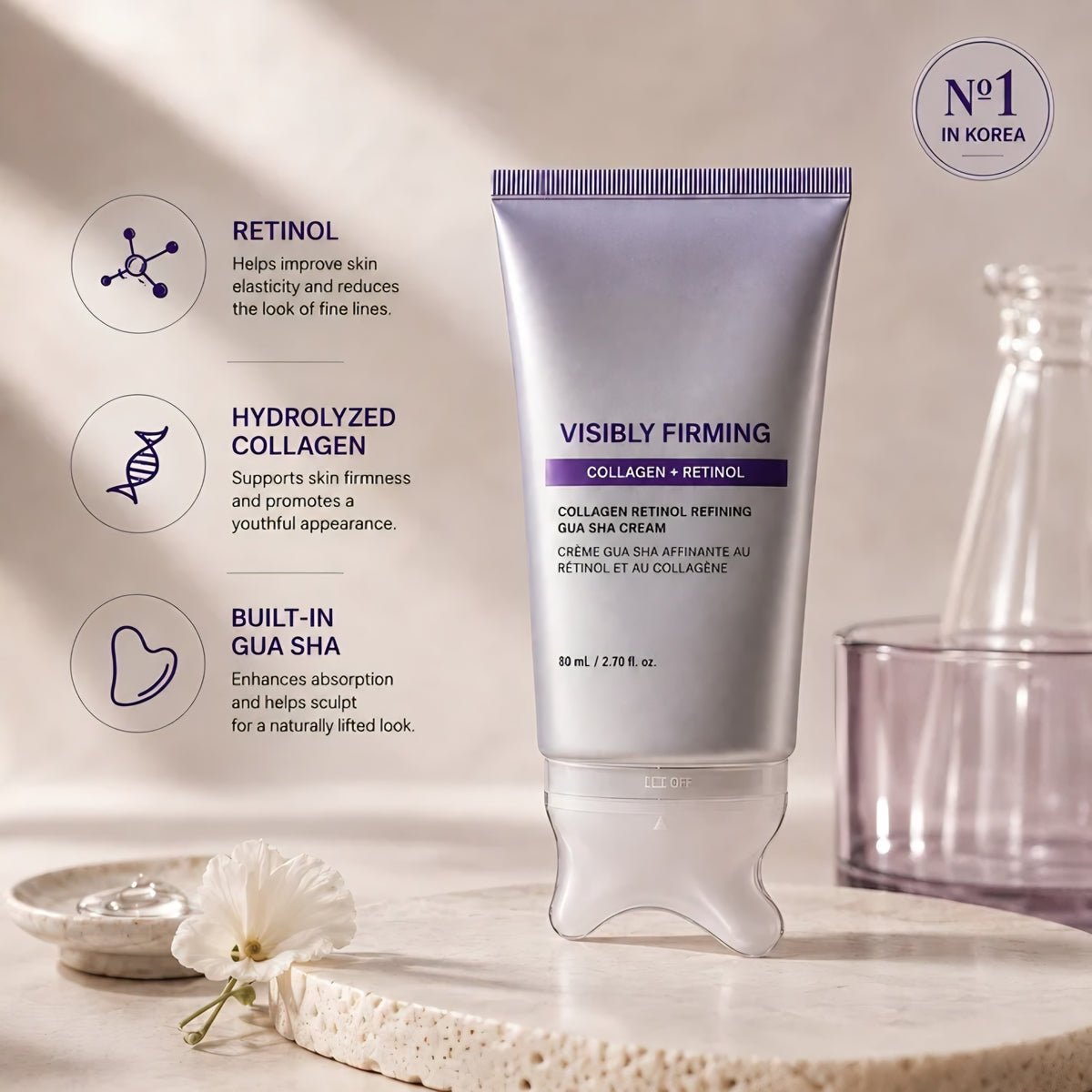 Purple Haenyo Visibly Firming gua sha cream tube standing on a stone tray beside a white flower, with labelled callouts for retinol, hydrolyzed collagen and the built-in gua sha applicator.